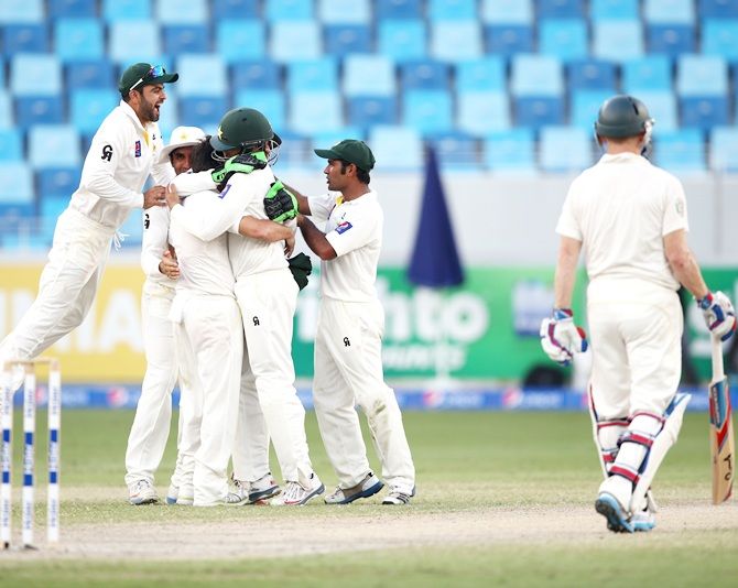 Pakistan players celebrate as Australian Captain, Michael Clarke is dismissed