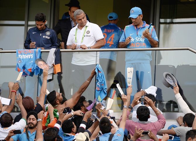 Mahendra Singh Dhoni of India signs autographs