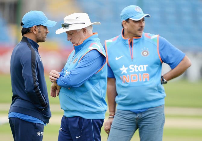 India coach Duncan Fletcher looks at his watch alongside Ravi Shastri and Mahendra Singh Dhoni during a nets session