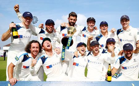 Yorkshire players celebrate with the County Championship Trophy after beating Nottinghamshire to secure the league during the fourth day of the LV County Championship at Trent Bridge in Nottingham on Friday