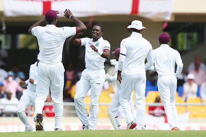 West Indies' Jerome Taylor (centre) celebrates taking the wicket of Jonathan Trott
