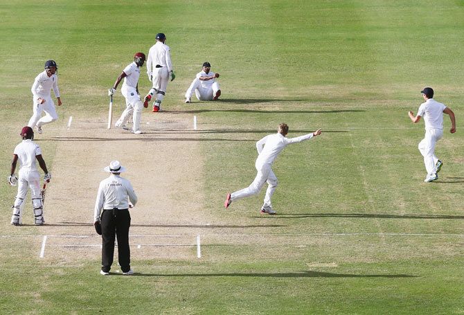 Joe Root (2nd from right ) begins his celebrations after claiming the wicket of Darren Bravo, caught by Chris Jordan at first slip