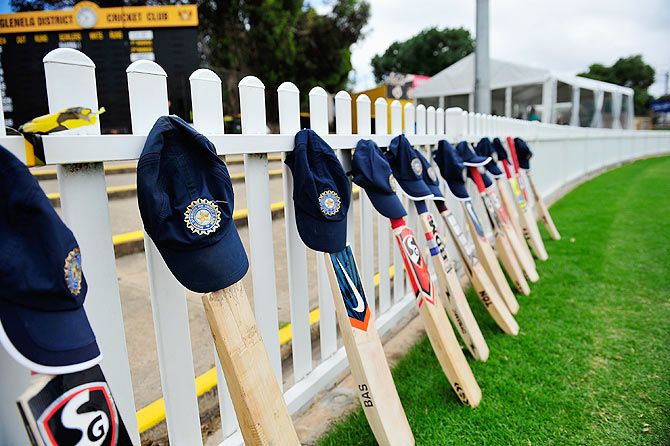 Cricket bats and caps are seen layed out by Indian players paying tribute to Phillip Hughes before the international tour match