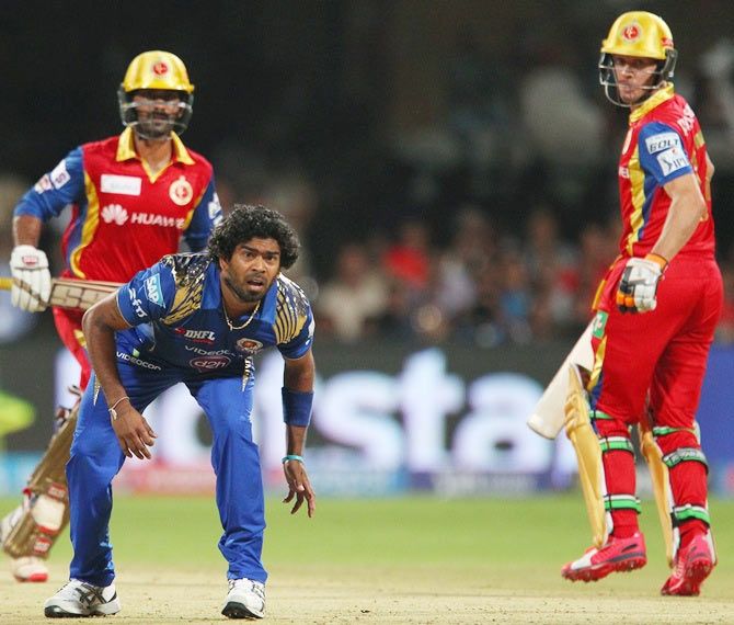   Lasith Malinga of the Mumbai Indians watches as the ball is caught to dismiss Dinesh Karthik of the Royal Challengers Bangalore