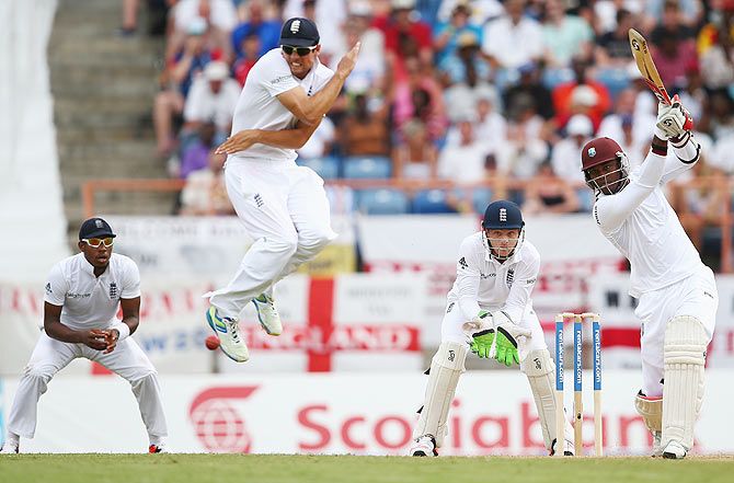 England captain Alastair Cook takes evasive action as West Indies' Marlon Samuels hits a cover drive on Day 1 of the 2nd Test match at the National Cricket Stadium in St George's in Grenada on Tuesday