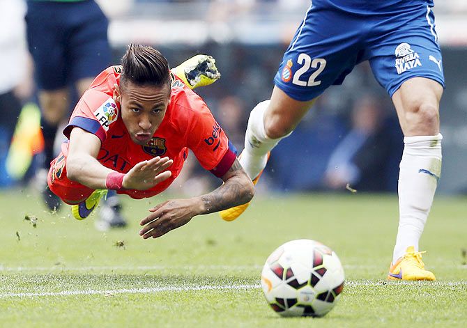 Barcelona's Neymar (left) goes flying as he is tackled by Espanyol's Lucas Vazquez during their La Liag match on Saturday