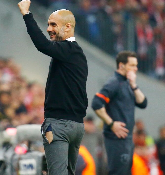 Bayern Munich's Josep Guardiola rips his trousers as he celebrates their fifth goal against Porto during their Champions League quater-final on April 21