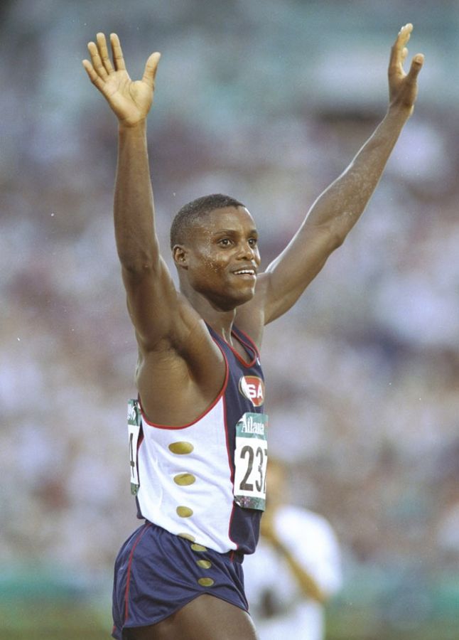 Carl Lewis of the USA raising his arms in victory after winning the gold medal in the Long Jump event during the 1996 Olympic Games in Atlanta, Georgia