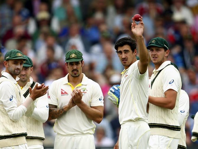 Mitchell Starc holds the ball aloft after claiming his fifth wicket of the innings