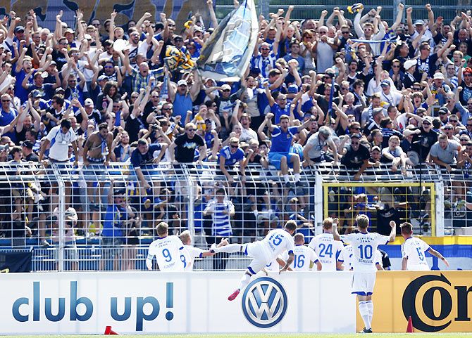 Players of fourth division FC Carl Zeiss Jena celebrate their goal against Hamburg SV during their German Cup (DFB Pokal) first round soccer match in Jena, Germany, on Sunday