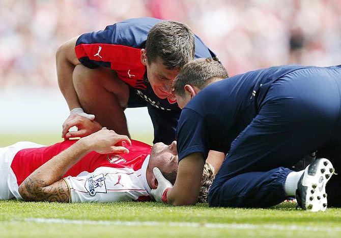 Arsenal's Olivier Giroud receives treatment after sustaining an injury following his clash with West Ham's James Tomkins on Sunday