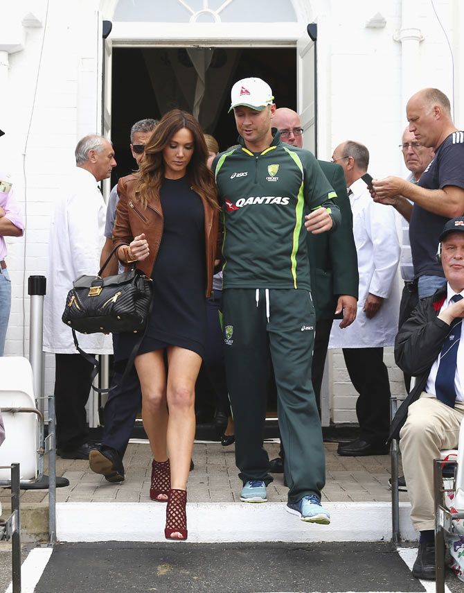 Australia's Michael Clarke with his pregnant wife Kyly, walk onto the field after he announced his retirement on Saturday