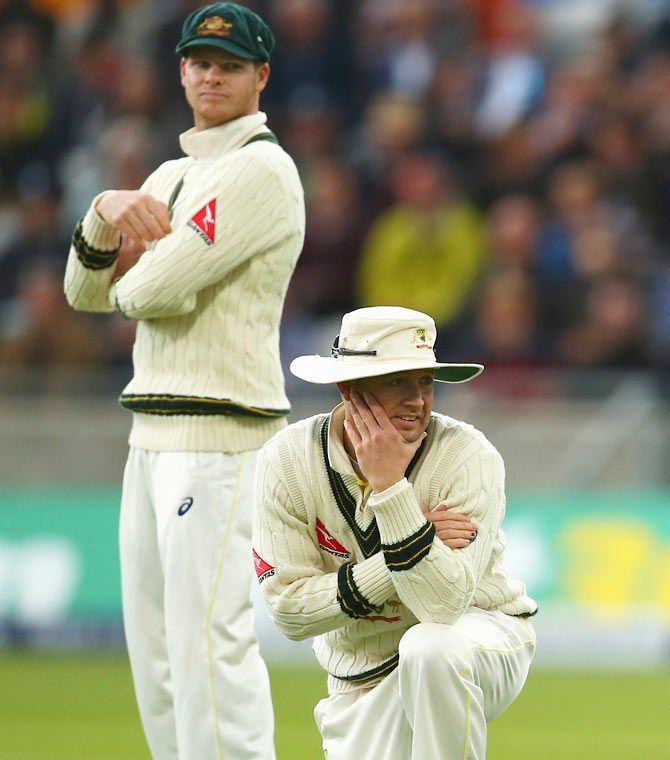 Australia's Michael Clarke, right, and Steven Smith look on