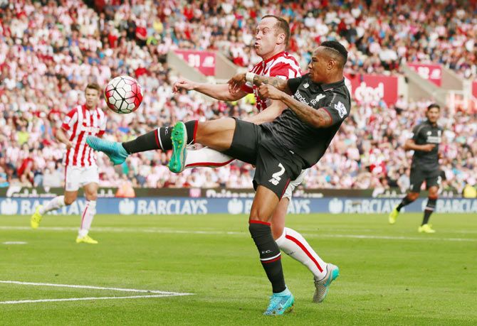 Liverpool's Nathaniel Clyne in action with Stoke's Charlie Adam