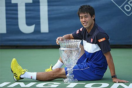 Japan's Kei Nishikori celebrates with the trophy after defeating United States' John Isner in the men's singles final during the Citi Open at Rock Creek Park Tennis Center in Washington, DC, on Saturday