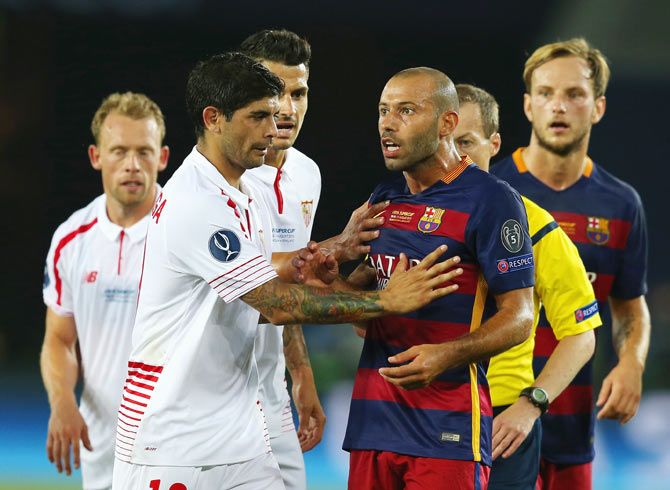 Sevilla's Ever Banega gets into a minor scuffle with Barcelona's Javier Mascherano