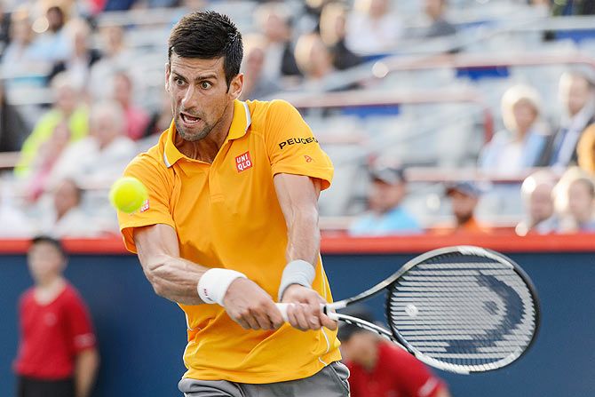 Serbia's Novak Djokovic plays a return against Brazil's Thomaz Bellucci during their 2nd round match of the Rogers Cup at Uniprix Stadium in Montreal, Canada, on Tuesday