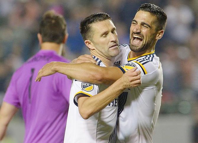 Los Angeles Galaxy midfielder Sebastian Lletget (17) celebrates after forward Robbie Keane (7) scored his third goal of the game in the second half against Toronto FC at StubHub Center in Carson, California on Saturday