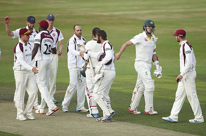 The players from Australia and Northamptonshire teams greet each other after the match was drawn on Day 3 of the tour match at The County Ground Northampton, England, on Sunday