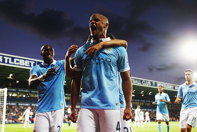 Manchester City's Vincent Kompany (right) is ecstatic as he celebrates their third goal of the night against West Bromwich Albion on Monday, August 10