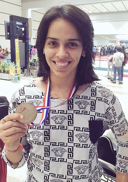 Saina Nehwal poses with her silver medal after losing the World Badminton Championships final to Carolina Marin in Jakarta on Sunday