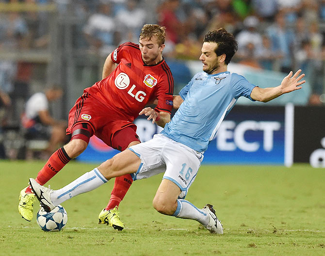 Bayer Leverkusen's Christoph Kramer (left) and SS Lazio's Marco Parolo in action during their UEFA Champions League qualifying round play-off first leg match at Olimpico Stadium in Rome on Tuesday