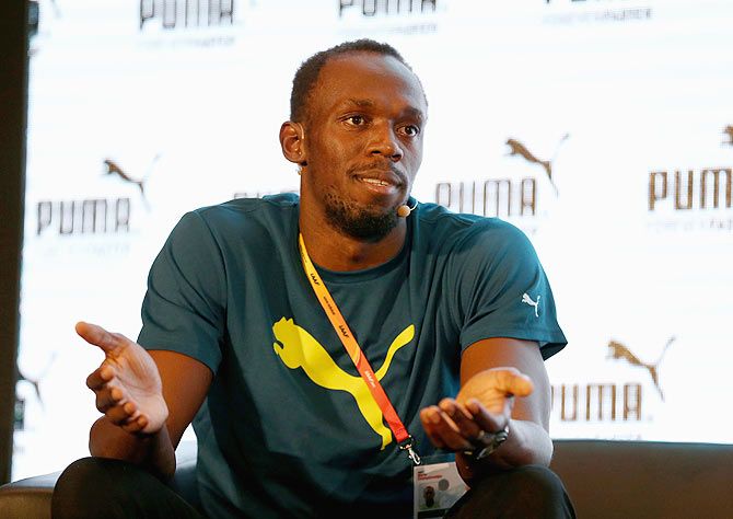 Usain Bolt talks with the media during a press conference on Thursday