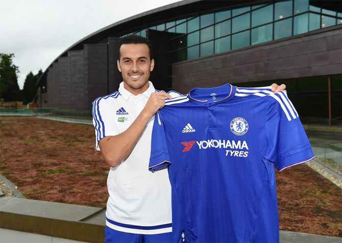 Pedro strikes a pose with the Chelsea shirt during his first photoshoot with the current EPL champions after his signing on Thursday