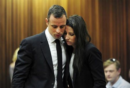 Olympic and Paralympic track star Oscar Pistorius stands beside his sister Aimee during court proceedings at the North Gauteng High Court in Pretoria
