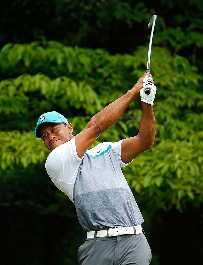 Tiger Woods tees off the ninth hole during the first round of the Wyndham Championship at Sedgefield Country Club on Thursday