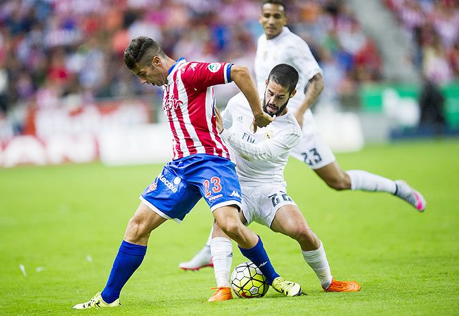Real Madrid's Isco challenges Sporting Gijon's Jony Rodriguez