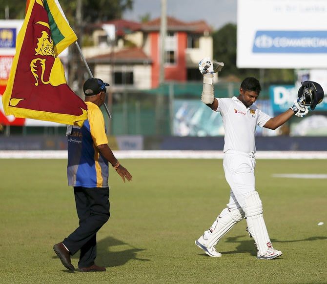 Sri Lanka's Kumar Sangakkara (right) acknowledges the fans as he walks off the field following his dismissal on the 4th day of the second Test match against India in Colombo on August 23