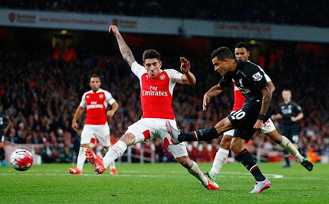 Liverpool's Philippe Coutinho takes a shot at goal under pressure from Arsenal's Hector Bellerin