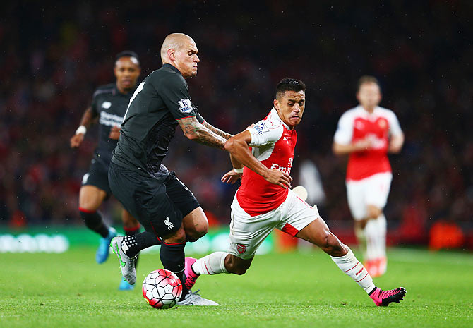 Arsenal's Alexis Sanchez is closed down by Liverpool's Martin Skrtel