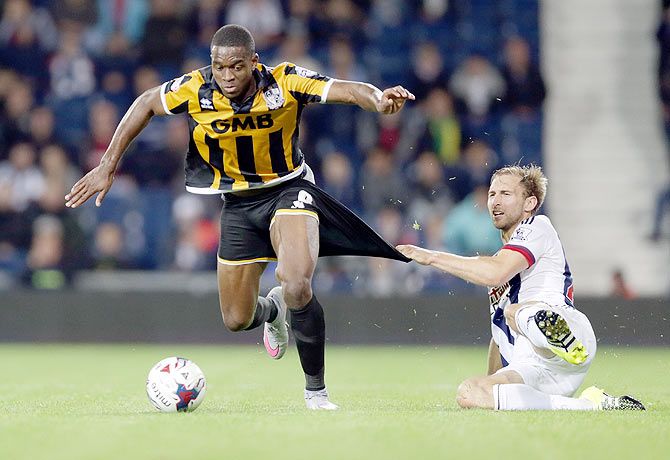 West Bromwich Albion's Craig Dawson fouls Port Vale's Uche Ikpeazu during their FA Cup second round match at The Hawthorns in West Bromwich on Tuesday