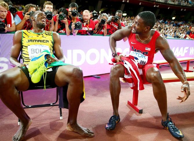 Gold medalist Usain Bolt, left, of Jamaica talks with silver medalist Justin Gatlin of the United States after the men's 200 metres final