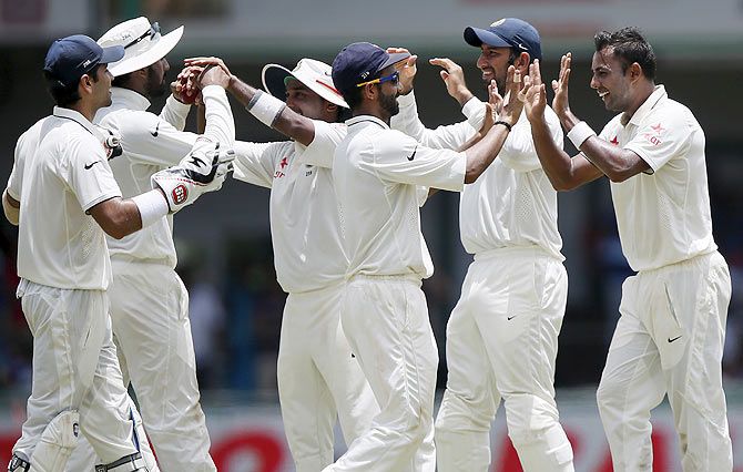 India's Stuart Binny (right) celebrates with his teammates after taking the wicket of Sri Lanka's Dimuth Karunaratne (not pictured)