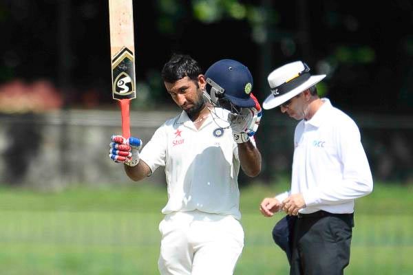 Cheteshwar Pujara acknowledges the crowd at the end of India's innings on Sunday
