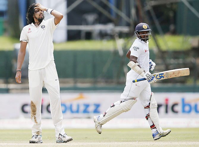 Sri Lanka's Kusal Perera (right) runs between wickets next to India's Ishant Sharma on Day 3 of the third Test in Colombo on Sunday