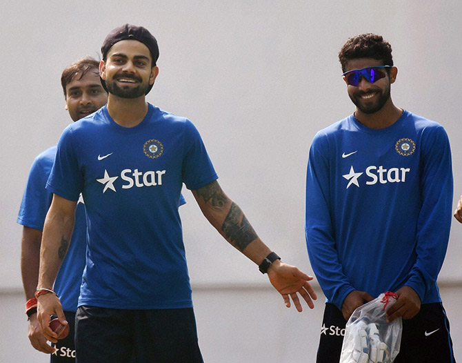 Indian captain Virat Kohli sharing light moment with Ravindra Jadeja as Amit Mishra looks on during a practice session 