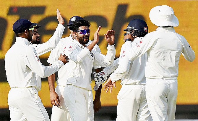 India's Ravindra Jadeja and teammates celebrate the wicket of South Africa's Hashim Amla during 2nd day of the fourth Test match at Ferozshah Kotla Stadium in New Delhi on Friday