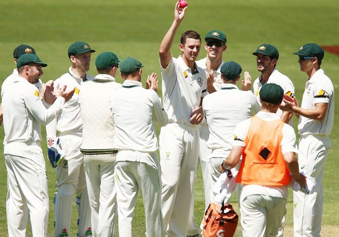 Australia’s Josh Hazlewood holds up the ball after taking 5 wickets in the Adelaide Test