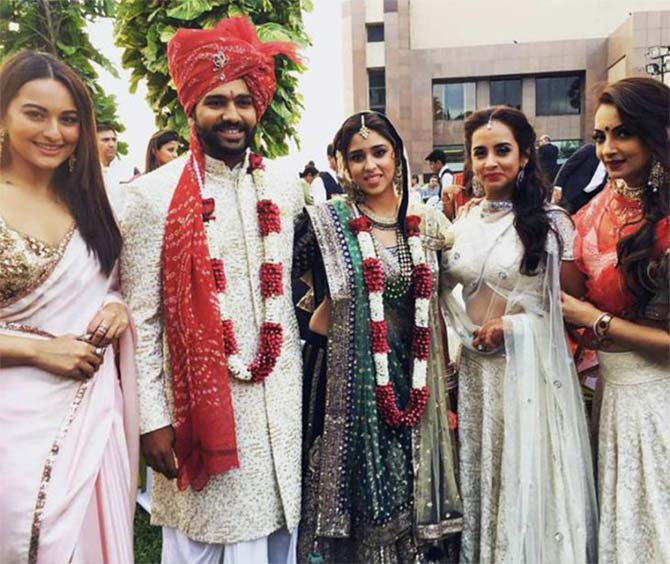 Bollywood actress Sonakshi Sinha poses with the couple 