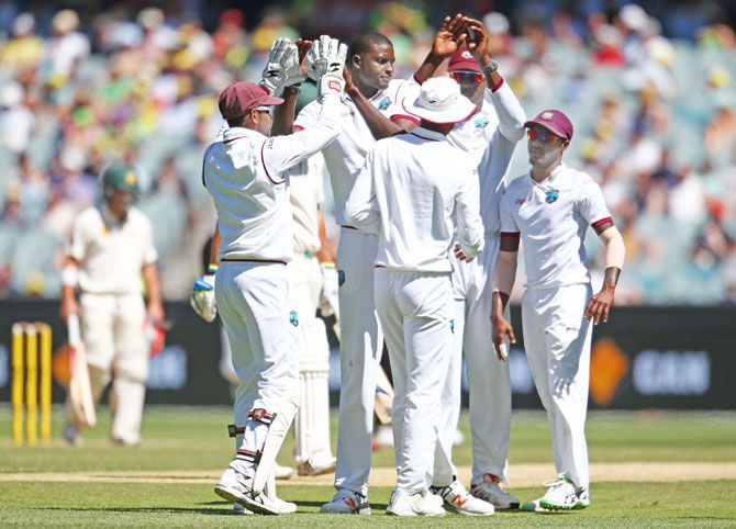 West Indies' Jason Holder is congratulated by his teammates after dismissing Australia's Joe Burns on Day 3 of the second Test at the Melbourne Cricket Ground on Monday