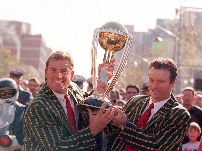 Shane Warne and Steve Waugh hold the World Cup Trophy during a ticker-tape parade through Melbourne, in celebration of the Australian Cricket team's victory over Pakistan in the 1999 Cricket World Cup final at Lords Cricket Ground, London