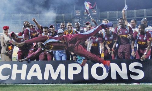 West Indies' Chris Gayle jumps as his teammates watch after winning the World Twenty20 in 2012