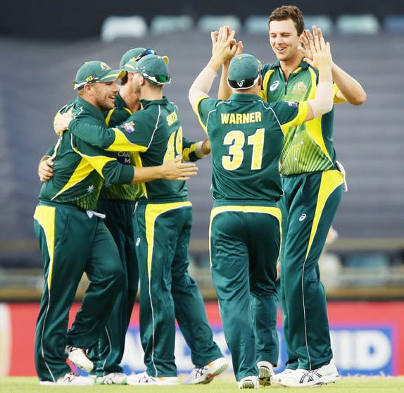 Josh Hazlewood of Australia celebrates with teammates after taking a wicket
