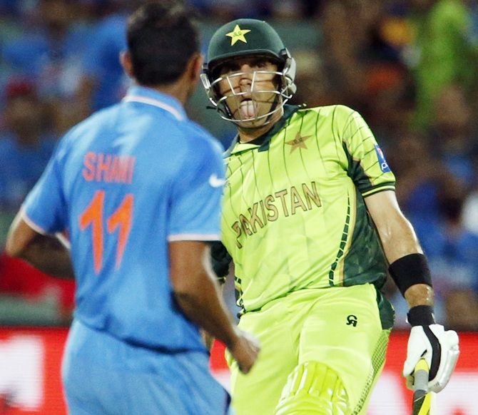 Pakistan batsman Misbah ul Haq pokes out his tongue after missing a short delivery by Indian bowler Mohammad Shami