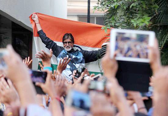Bollywood actor Amitabh Bachchan celebrates with India cricket fans after India beat Pakistan in their 2015 World Cup opener at the Adelaide Oval on Sunday