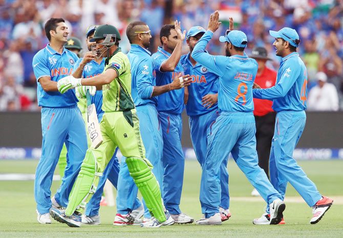 Mohammed Shami of India is congratulated by teammates after sclaping the wicket of Younis Khan